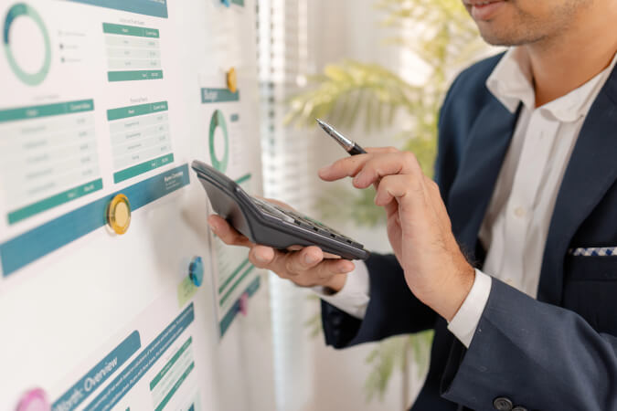 A finance and engineering lead reviewing a cloud cost dashboard together