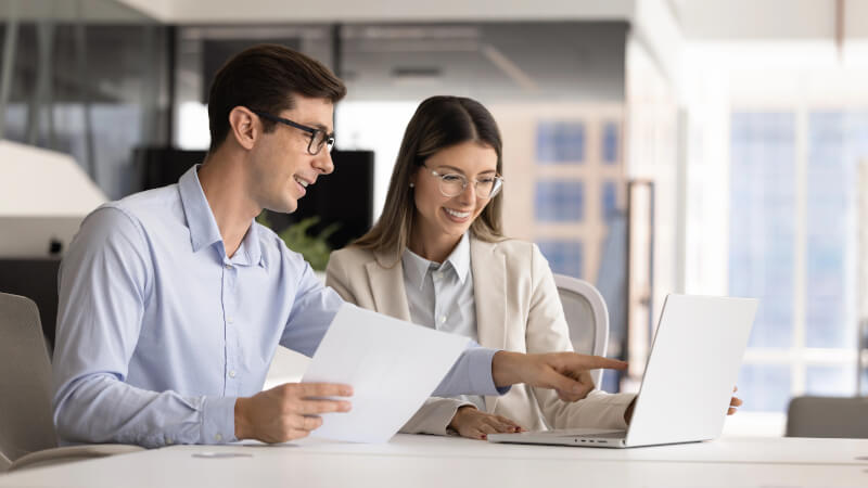 A founder and technical lead reviewing a security checklist/policy documents at a desk 